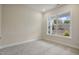 A carpeted bedroom with a large window offering views of the outdoors at 2537 Cedar Hedge Ct, Apex, NC 27523