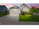 Beautiful white home featuring an attached garage and well-manicured landscaping at 2537 Cedar Hedge Ct, Apex, NC 27523