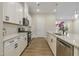 Elegant kitchen featuring white cabinets, quartz countertops, and stainless steel appliances at 2537 Cedar Hedge Ct, Apex, NC 27523