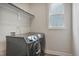 Laundry room featuring modern washer and dryer, and a window for natural light at 2537 Cedar Hedge Ct, Apex, NC 27523
