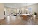 Bright living and dining area with wood floors and plenty of natural light at 2537 Cedar Hedge Ct, Apex, NC 27523