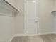 Walk-in closet with neutral carpet and white trim; a blank canvas for organizing wardrobe at 2537 Cedar Hedge Ct, Apex, NC 27523