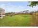 Large grassy backyard with a wooden fence, perfect for outdoor activities and entertaining at 2604 Fortrose Ln, Fuquay Varina, NC 27526