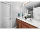 Bright bathroom with double sinks, white countertops, and a large vanity mirror at 2604 Fortrose Ln, Fuquay Varina, NC 27526