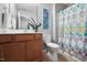 Well-lit bathroom with decorative shower curtain and a large single sink vanity at 2604 Fortrose Ln, Fuquay Varina, NC 27526
