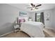 Bright bedroom features neutral tones, a ceiling fan, and sunny window at 2604 Fortrose Ln, Fuquay Varina, NC 27526