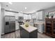 Modern kitchen featuring white cabinets, stainless steel appliances, and a dark island at 2604 Fortrose Ln, Fuquay Varina, NC 27526