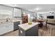 Open kitchen with white cabinets, stainless appliances, and a view to the dining area at 2604 Fortrose Ln, Fuquay Varina, NC 27526