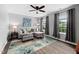 Cozy living room features stylish decor, a ceiling fan, wood floors, and natural light at 2604 Fortrose Ln, Fuquay Varina, NC 27526