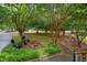 Secluded backyard featuring a fire pit, patio furniture, and mature trees at 275 Eagle Stone Rdg, Youngsville, NC 27596