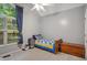 Cozy bedroom features a single bed, soft carpet, and a bright window with natural light at 275 Eagle Stone Rdg, Youngsville, NC 27596