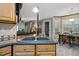 Close-up of a kitchen sink with a view of the dining and living area at 275 Eagle Stone Rdg, Youngsville, NC 27596
