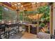 Outdoor kitchen with wooden floors, a grill, and counter space for cooking in backyard at 275 Eagle Stone Rdg, Youngsville, NC 27596