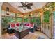 Inviting covered porch with comfortable seating, a ceiling fan, and views of the lush greenery at 275 Eagle Stone Rdg, Youngsville, NC 27596