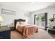 Bedroom featuring natural light from two windows and french doors, complemented by soft carpet at 290 Quarter Gate Trce, Chapel Hill, NC 27516