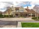 Exterior of the clubhouse with manicured landscaping, covered porch, and cobblestone accents at 290 Quarter Gate Trce, Chapel Hill, NC 27516