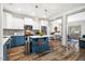 Modern kitchen with white upper cabinets, blue lower cabinets, and a center island at 290 Quarter Gate Trce, Chapel Hill, NC 27516