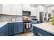Modern kitchen featuring stainless steel appliances and white and blue cabinets at 290 Quarter Gate Trce, Chapel Hill, NC 27516