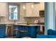 Modern kitchen with white cabinets, blue lower cabinets, and pendant lighting at 290 Quarter Gate Trce, Chapel Hill, NC 27516