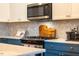 Close-up of a modern kitchen featuring stainless steel appliances and white backsplash at 290 Quarter Gate Trce, Chapel Hill, NC 27516