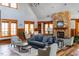 Spacious living room with hardwood floors, stone fireplace, large windows, and comfortable seating at 290 Quarter Gate Trce, Chapel Hill, NC 27516