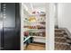 Organized pantry with ample shelving and storage space, conveniently located by the stairs at 290 Quarter Gate Trce, Chapel Hill, NC 27516