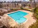 Large swimming pool featuring lap lanes, lounge chairs and covered seating area surrounded by the community homes at 290 Quarter Gate Trce, Chapel Hill, NC 27516