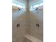 Modern tiled shower with dual shower heads and controls under two windows at 290 Quarter Gate Trce, Chapel Hill, NC 27516