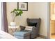 Comfortable sitting area with a cushioned chair, side table with plant, and neutral decor at 290 Quarter Gate Trce, Chapel Hill, NC 27516