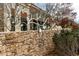 Decorative stone wall with an artistic metal sculpture and landscaping surrounding the community at 290 Quarter Gate Trce, Chapel Hill, NC 27516