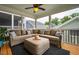 Cozy sunroom with comfortable sectional seating and outdoor views through screened windows at 290 Quarter Gate Trce, Chapel Hill, NC 27516