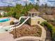 Community waterslide featuring a tower structure, dual slides, and a splash pool surrounded by landscaping at 290 Quarter Gate Trce, Chapel Hill, NC 27516
