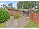 Exterior view of backyard with a brick house, and covered screened in porch at 3114 Alabama Ave, Durham, NC 27705