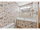 Full bathroom with floral wallpaper, a mirror, and a single vanity at 3114 Alabama Ave, Durham, NC 27705
