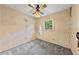Bedroom with carpeted floor, overhead fan and light, window, and dated wallpaper at 3114 Alabama Ave, Durham, NC 27705