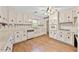 Traditional kitchen with light cabinetry, durable flooring, and modern appliances at 3114 Alabama Ave, Durham, NC 27705