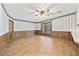 Open-concept living room with wood-look flooring and French doors leading to outdoor space at 3114 Alabama Ave, Durham, NC 27705