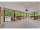 Spacious screened-in porch with wooden floors, ceiling fan, and views of the backyard and pool at 3114 Alabama Ave, Durham, NC 27705