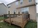 Spacious wooden deck with black metal railings overlooking the backyard, ideal for entertaining or relaxing outdoors at 319 Brinkley Cir, Mebane, NC 27302