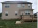 Back of home featuring a spacious backyard and a wooden deck, perfect for outdoor enjoyment and relaxation at 319 Brinkley Cir, Mebane, NC 27302