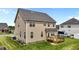 Wide backyard with a wooden deck, green lawn, and well-maintained exterior featuring two-car garage at 319 Brinkley Cir, Mebane, NC 27302