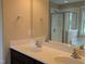 Bathroom featuring double sinks, a large mirror, and a glass-enclosed shower and separate tub at 319 Brinkley Cir, Mebane, NC 27302