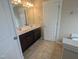 Bathroom featuring double sinks, a large mirror, dark wood vanity, and a white door at 319 Brinkley Cir, Mebane, NC 27302
