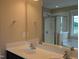Bathroom featuring double sinks, a large mirror, and a glass-enclosed shower and separate tub at 319 Brinkley Cir, Mebane, NC 27302