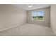 Minimalist bedroom features neutral walls, a ceiling fan and new carpet and large windows at 319 Brinkley Cir, Mebane, NC 27302