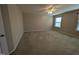 Bedroom with neutral tones, ceiling fan and two windows providing natural light at 319 Brinkley Cir, Mebane, NC 27302