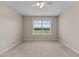 This bedroom features carpeted floors and a window bringing in natural light at 319 Brinkley Cir, Mebane, NC 27302