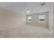 A spacious bedroom with neutral walls, carpet, ceiling fan, and two windows offering natural light at 319 Brinkley Cir, Mebane, NC 27302
