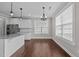 Bright dining area features new wood flooring, many windows and modern lighting at 319 Brinkley Cir, Mebane, NC 27302
