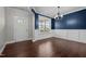 Dining room with dark wood floors, chair rail, large window, and chandelier at 319 Brinkley Cir, Mebane, NC 27302